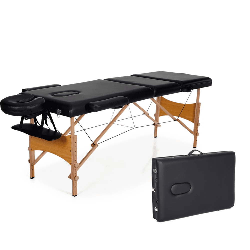 A black massage table with wooden legs and carrying case.