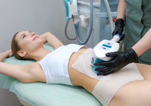 A woman getting her body worked on by an esthetician.